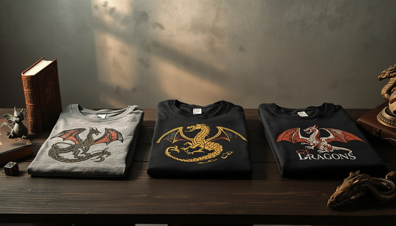 Folded dragon graphic t-shirts displayed on a wooden table with subtle fantasy props under warm natural lighting.
