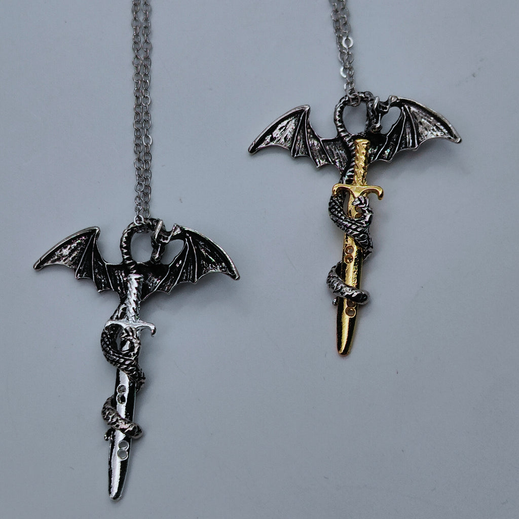 Silver and gold dragon sword pendant necklaces shown side by side