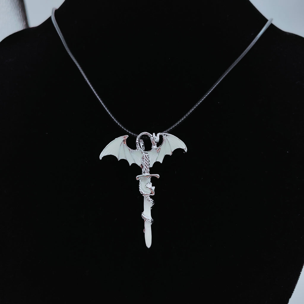 Silver-tone dragon sword necklace displayed on black jewellery bust
