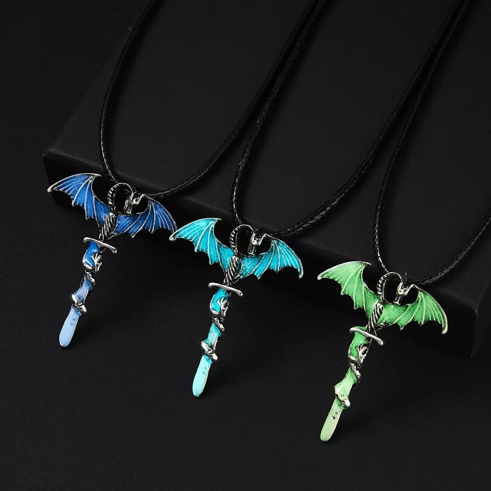 Three dragon sword necklaces displayed in different colours