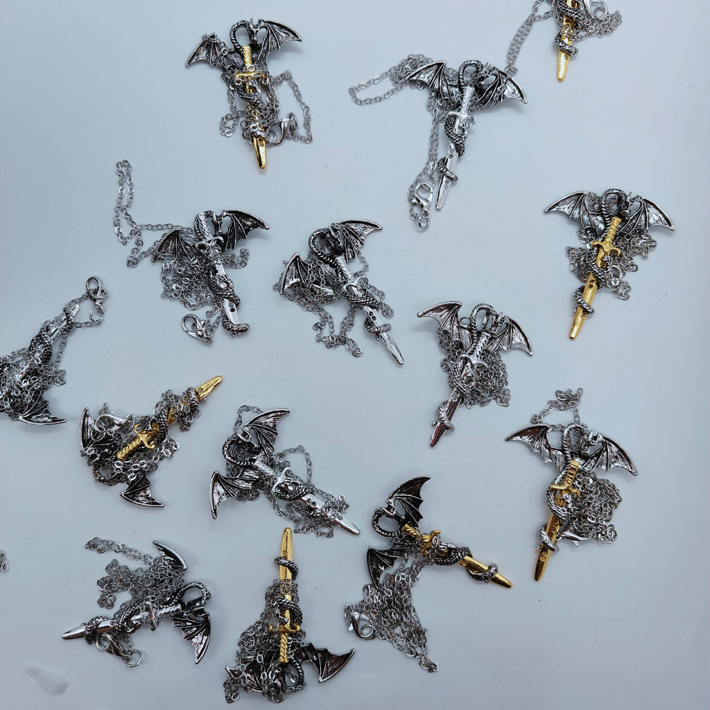 Collection of silver and gold dragon sword pendant necklaces with chains
