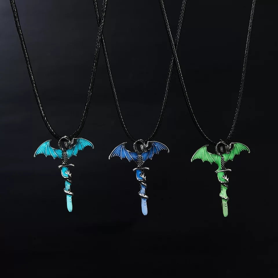 Blue, light blue and green dragon sword necklaces on black background