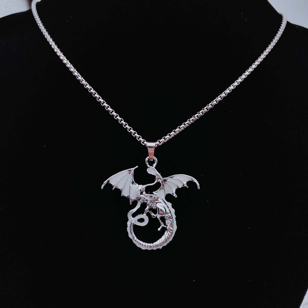 Light-coloured glow in the dark flying dragon necklace