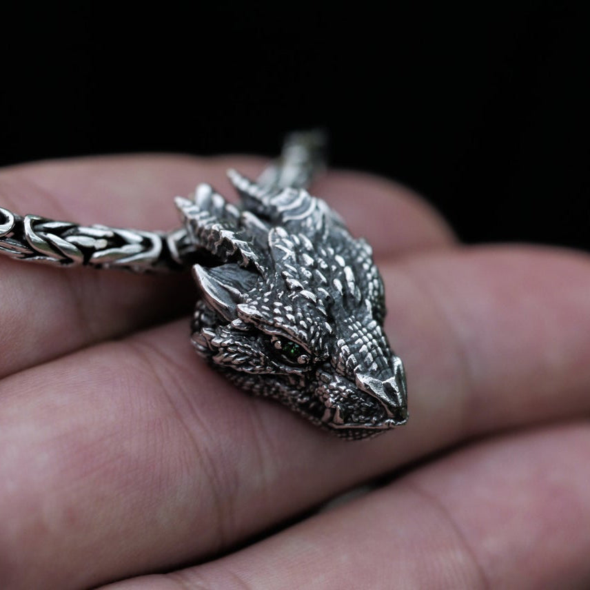 1. Gothic dragon head necklace displayed against a hand showing pendant size and intricate detailing