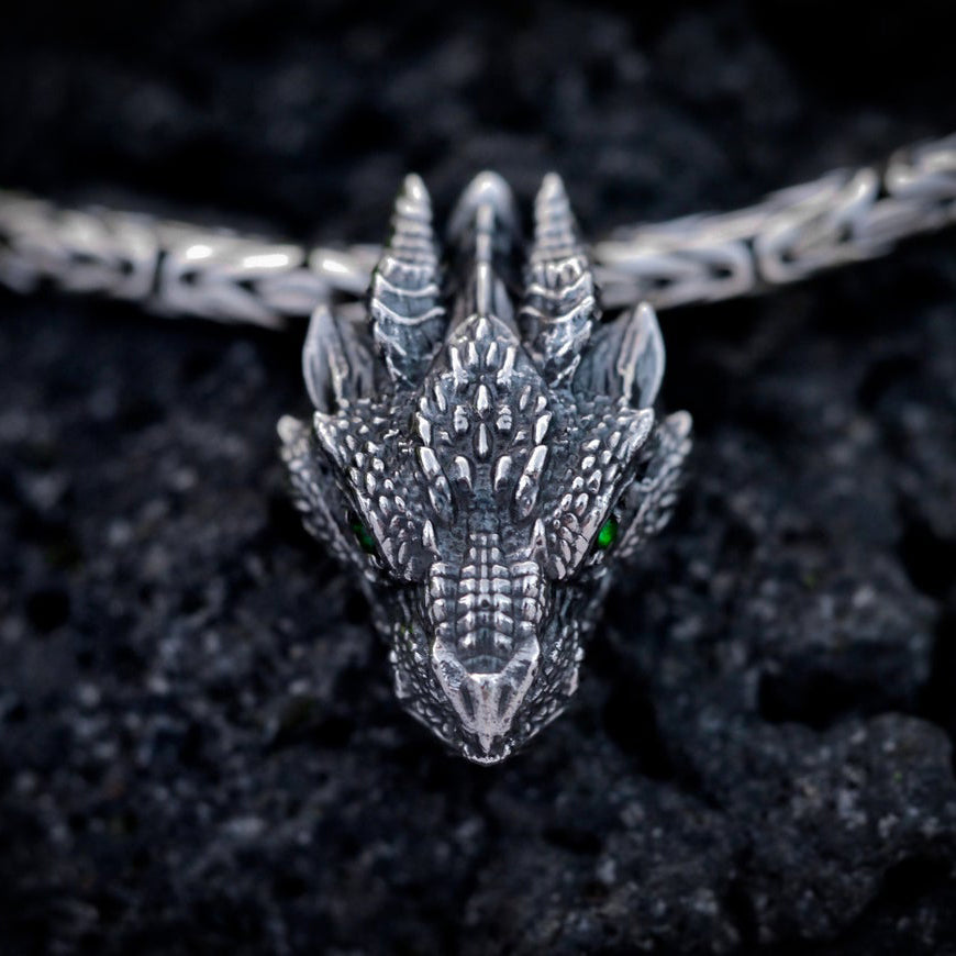 Antique silver gothic dragon head pendant with green eyes and intricately sculpted scales