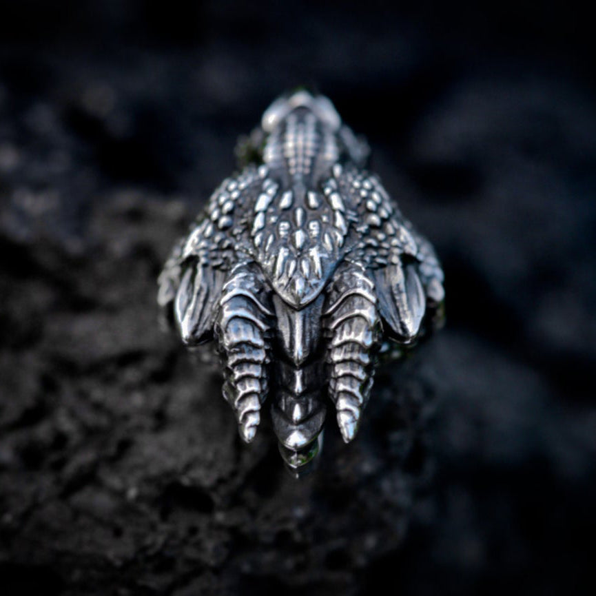 Close-up of gothic dragon head pendant showing detailed horns and armoured scales