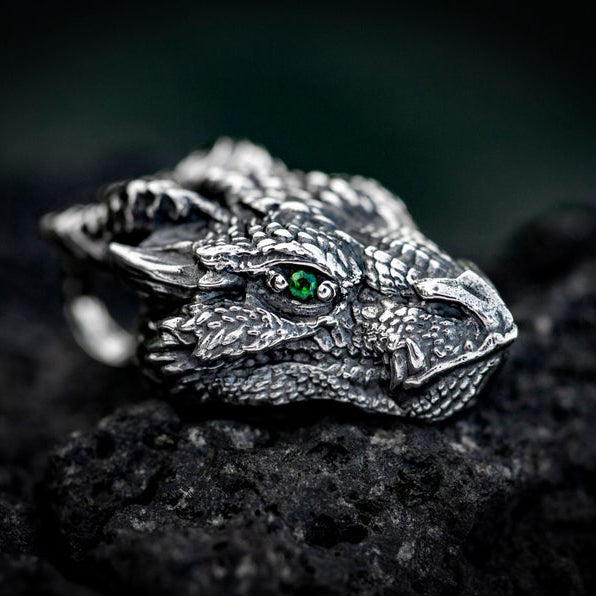 Side profile of gothic dragon head necklace showing green eye, horns and detailed silver finish