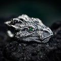 Side profile of gothic dragon head necklace showing green eye, horns and detailed silver finish