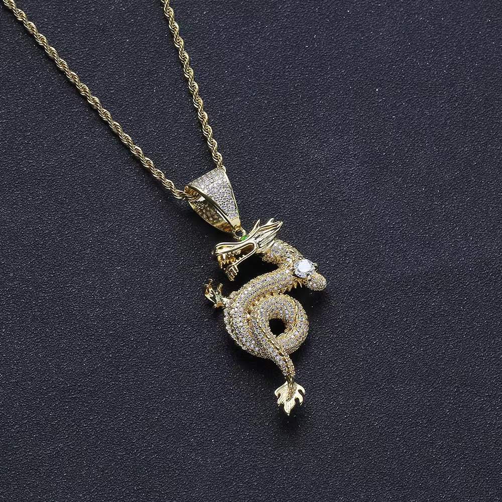 Gold-tone jewelled dragon serpent pendant with sparkling stones, decorative white stone and matching chain.