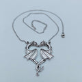 Silver-tone twin dragon heart pendant with matching chain and adjustable clasp