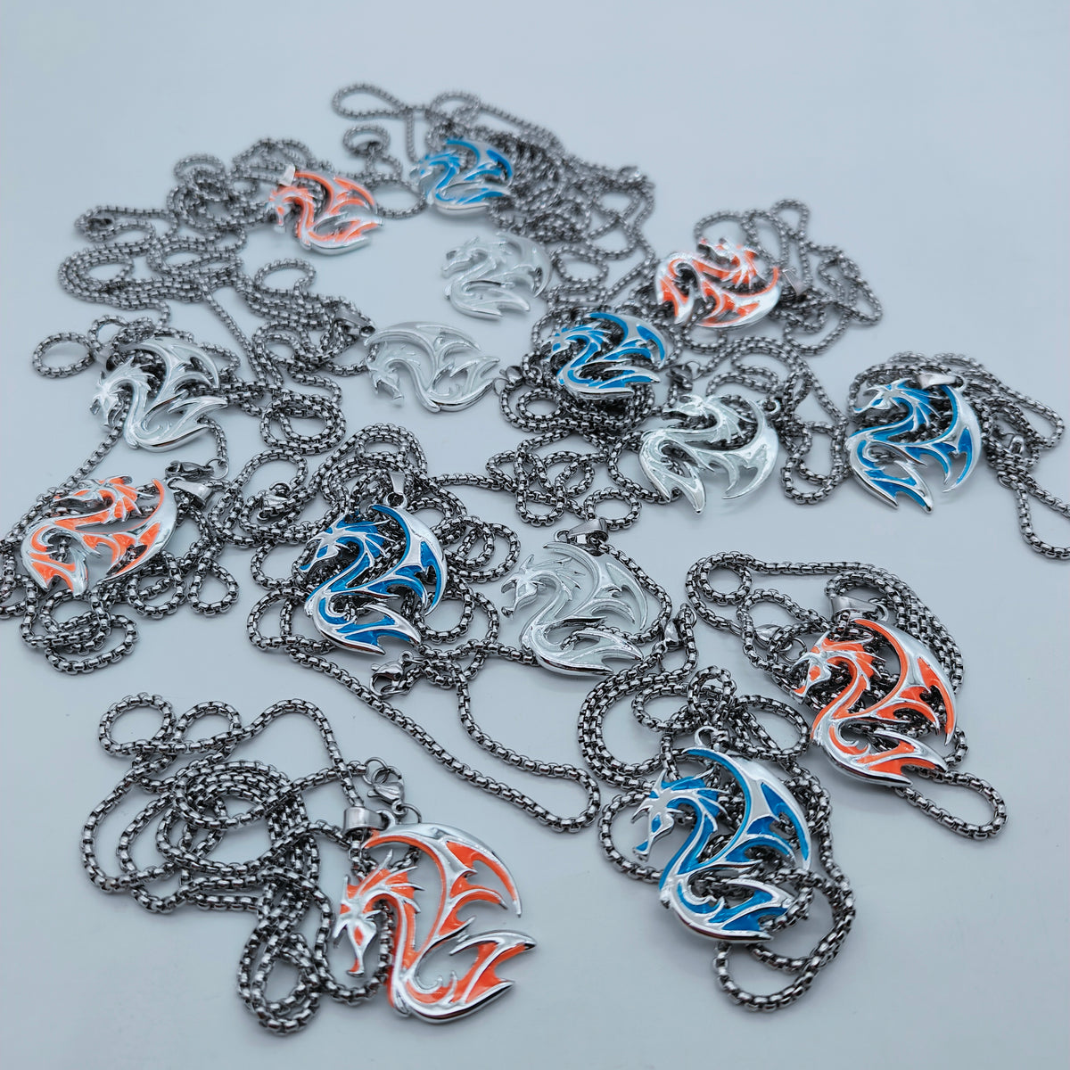 Assortment of tribal dragon pendant necklaces with silver-tone chains