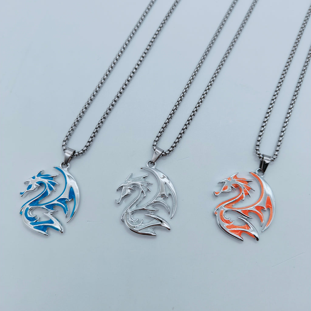 Silver-tone tribal dragon pendant necklaces showing coloured and pale daylight finishes