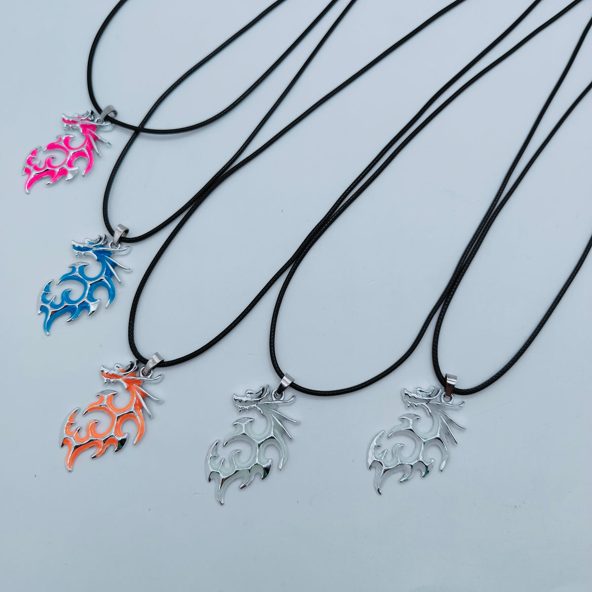 Tribal Flame glow in the dark dragon pendant necklaces in assorted colours with black cords
