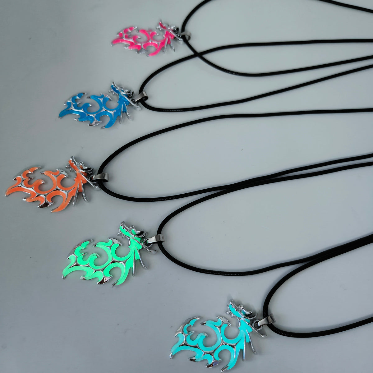 Tribal Flame glow in the dark dragon pendant necklaces in assorted colours with black cords