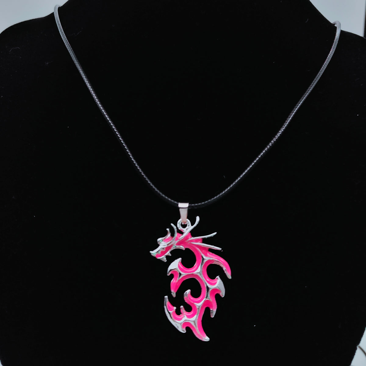 Pink tribal flame dragon necklace featuring intricate swirling dragon design