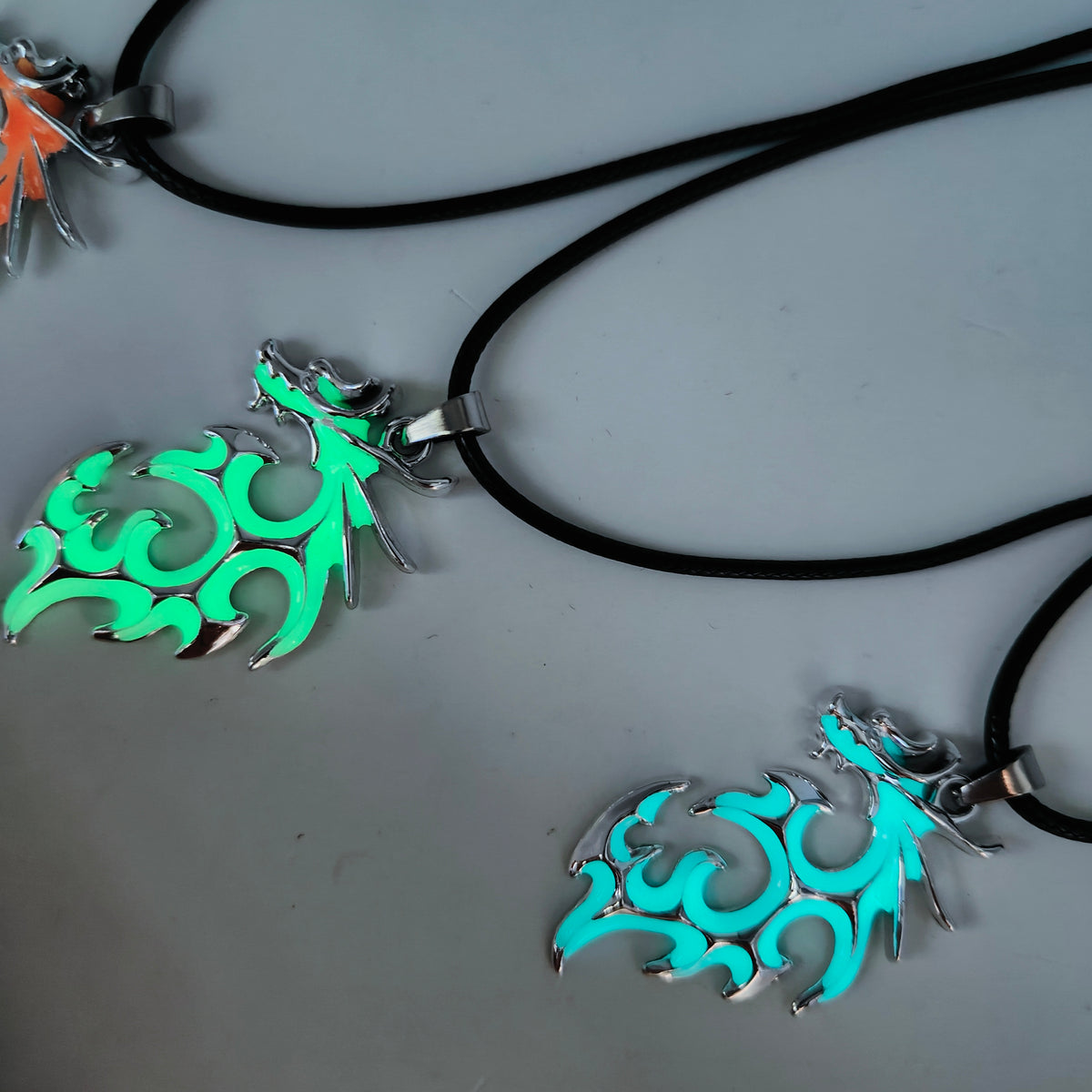 Tribal Flame glow in the dark dragon pendant necklaces in assorted colours with black cords